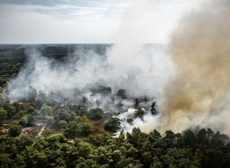 Feuerwehrleute und Hubschrauber bekämpfen Brand in Naturschutzgebiet in Niederlanden